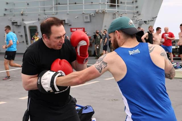 Two of Queen Elizabeth's crew throw down some punches for the grassroots sports day in the Mediterranean. Photo: Royal Navy/Twitter.