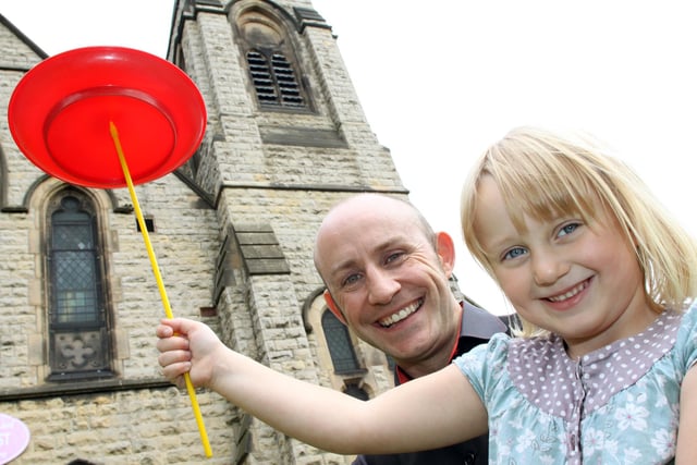 Lydia North, 5, is taught how to spin plates by Paul Brown from Magical Mayhem at Bolsover Methodist Church's Freedom Fest circus skills session in 2010.