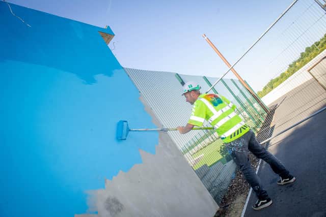 Artist, My Dog Sighs, begins to paint a mural on the building of Hilsea Lido Swimming Pool on 20th July 2020. 

Pictured:  Artist, My Dog Sighs applying the first coat of paint on the Hilsea Swiming Pool building.

Picture: Habibur Rahman

Picture: Habibur Rahman