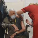 PORTSMOUTH, ENGLAND - DECEMBER 08: Michael Tibbs, 99, being administered the Pfizer/BioNtech covid-19 vaccine by Liz Rix, Chief Nurse at Queen Alexandra Hospital.  (Photo by Ewan Galvin - Pool / Getty Images)