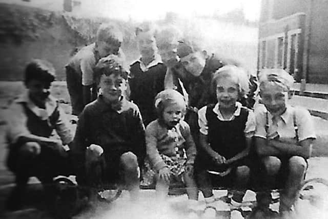 Ron Gregory, far left, with friends sitting on his go-kart.