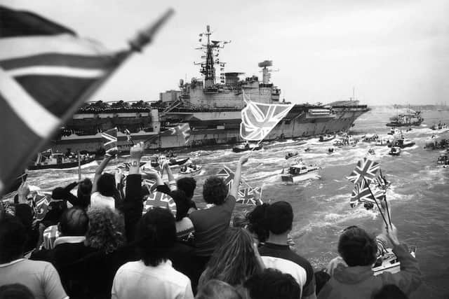 HMS Hermes returning to a frenzied Portsmouth Harbour in 1982, post-Falklands war.