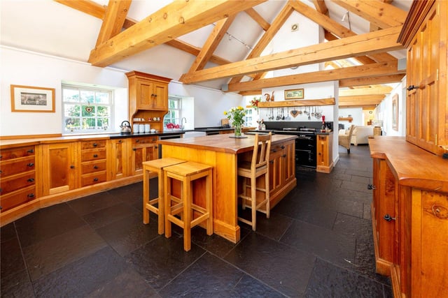 The open plan kitchen boasts timber from Douglas Fir trees from within the grounds, which have been used to create striking exposed cross beams. The kitchen itself is handcrafted from oak, also from within the estate