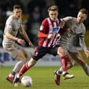 Lincoln's Jake Hesketh battles with Tom Naylor - now both clubs are critical of the Football League's salary cap proposals. Picture: Daniel Chesterton/phcimages.com