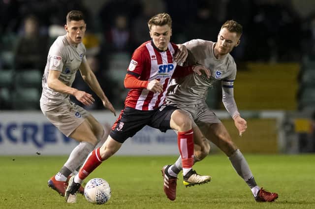 Lincoln's Jake Hesketh battles with Tom Naylor - now both clubs are critical of the Football League's salary cap proposals. Picture: Daniel Chesterton/phcimages.com