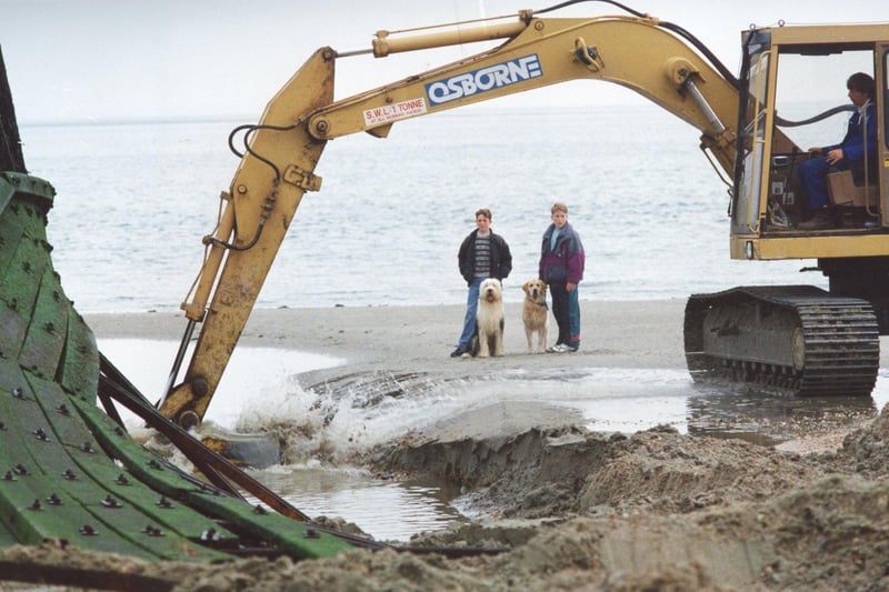Two boys and their dogs look on as work is carried out on the sea defences at Sandy Point, Hayling Island, September 25 1992. The News PP3407