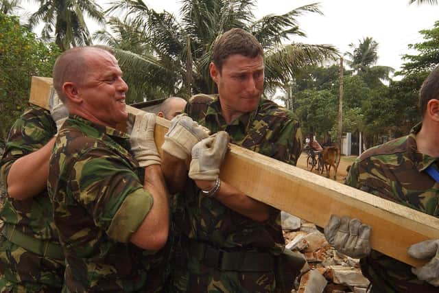 Royal Navy and Royal Fleet Auxillary personnel from HMS Chatham and RFA Diligence provide aid to locals in Batticoloa, one of the worst hit areas in the town by repairing and refloating some of the fishing vessels which have been swept some 2K along the shoreline.