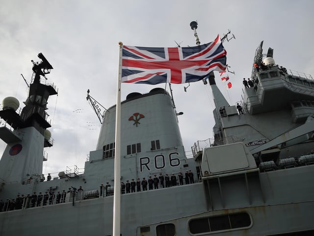 The crew of HMS Illustrious wave as she arrived into Portsmouth Harbour on January 10, 2014 in Portsmouth. The ship returned with her 650 crew after a five month deployment to South East Asia delivering Aid relief to victims of  Typhoon Haiyan in the Philippines. Photo by Dan Kitwood/Getty Image