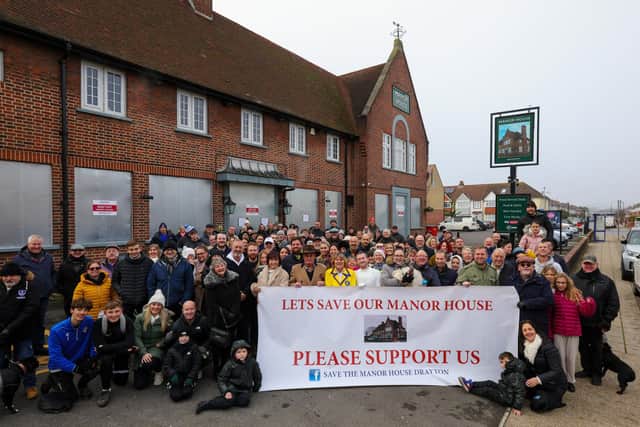 Campaigners outside the Manor House pub, Drayton, where they objected to owners Greene King's closure of the community hub last November. Picture: Chris Moorhouse