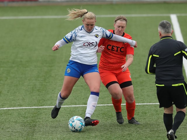 Hawks' Jodie Burchell holds off Gosport Falcons' Laura Cassey. Picture: Dave Haines