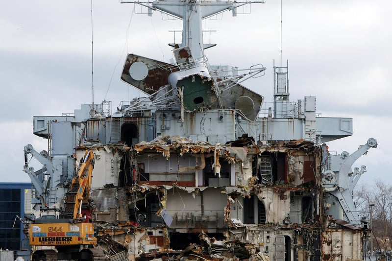 Giant demolition machines eat away at the hulk of the Falklands veteran ship HMS Intrepid as it sits in a dry dock while it is scrapped on March 4, 2009 in Liverpool. Photo by Christopher Furlong/Getty Images)