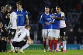 Pompey's Ryan Williams with Peterborough's Jonson Clarke-Harris after the Blues' 2-0 win. Picture: Joe Pepler