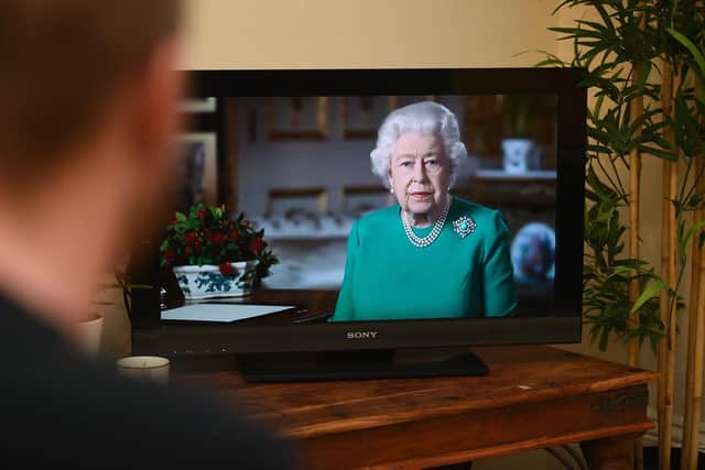 People in Wandsworth, London, watch Queen Elizabeth II deliver her address to the nation and the Commonwealth in relation to the coronavirus epidemic. Photo credit should read: Kirsty O'Connor/PA Wire