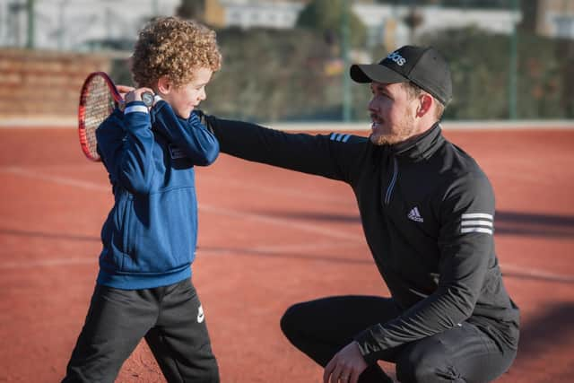 The Avenue Tennis head coach Ashley Neaves, right, offers some words of advice to a young player