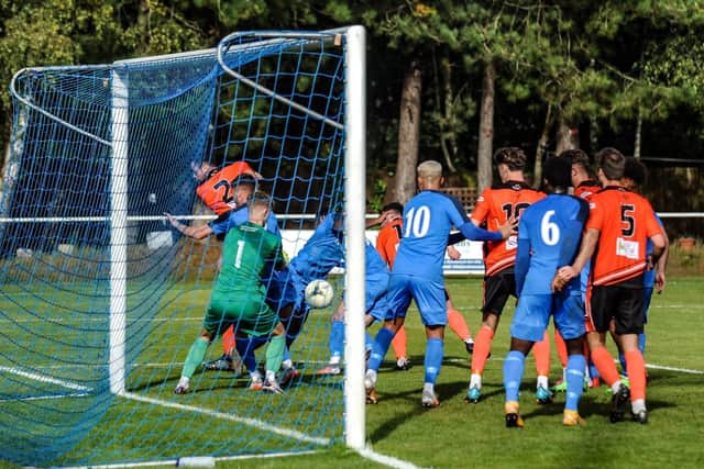 Ryan Wilkins (2) scores Portchester's second goal in their 3-0 Wessex League win at Christchurch. Picture by Daniel Haswell.