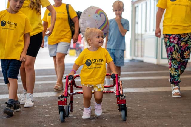 Esme Groves (2) sets off for her charity walk from South Parade Pier to raise money for charity Shine.