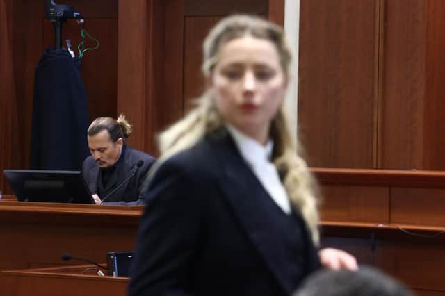 Amber Heard (R) speaks to her legal team as US actor Johhny Depp (L) returns to the stand after a lunch recess during the 50 million US dollar Depp vs Heard defamation trial at the Fairfax County Circuit Court in Fairfax, Virginia, April 21, 2022. Picture: JIM LO SCALZO/POOL/AFP via Getty Images
