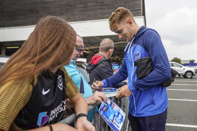 Pompey striker Joe Pigott signs autographs for fans outside Fratton Park