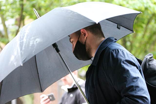 Former PCSO Joshua Fitzjohn leaves Portsmouth Crown Court wth an umbrella having being sentenced for coercive control of his wife (jpns 180621-15)