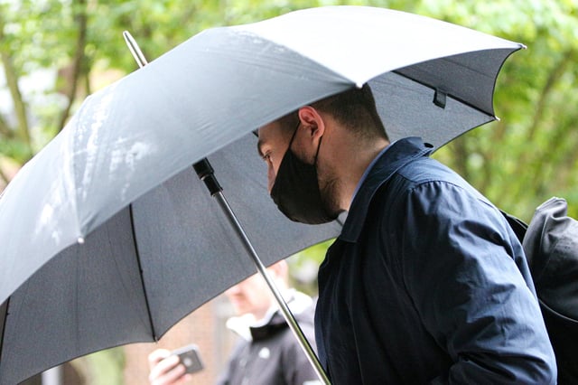 Former PCSO Joshua Fitzjohn leaves Portsmouth Crown Court wth an umbrella having being sentenced for coercive control of his wife (jpns 180621-15)