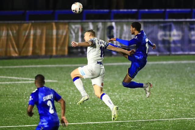 St Albans' Joy Mukena goes in high on Hawks striker Danny Wright. Picture by Dave Haines