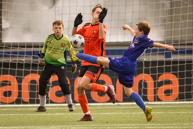 Action from the Portsmouth Youth League Stuart Madigan Cup final between Baffins Milton Rovers Vipers U14s (all blue kit) and AFC Portchester Vikings U14s (orange and black kit). Picture: Keith Woodland (190321-955)