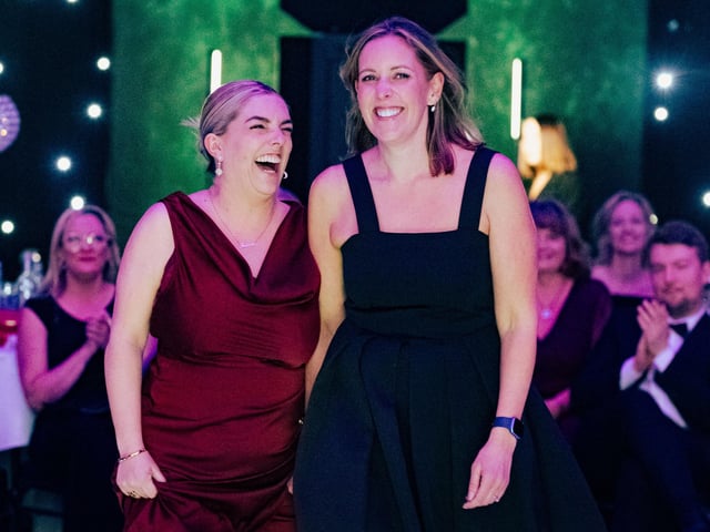Tatum Isaacs and business owner, Sarah Roads, make their way to the stage after SLR Recruitment Solutions won Overall Business of the Year