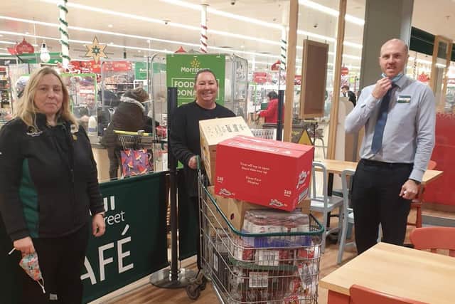 (left to right) Morrisons community champions Karen Withey and Sara Potten alongside Horndean store manager Jay Todd and the first donation of goods for The Cowplain Christmas Food Appeal.