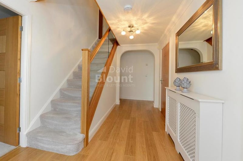 Another view of the attractive entrance hall. It includes a handy cupboard under the stairs.