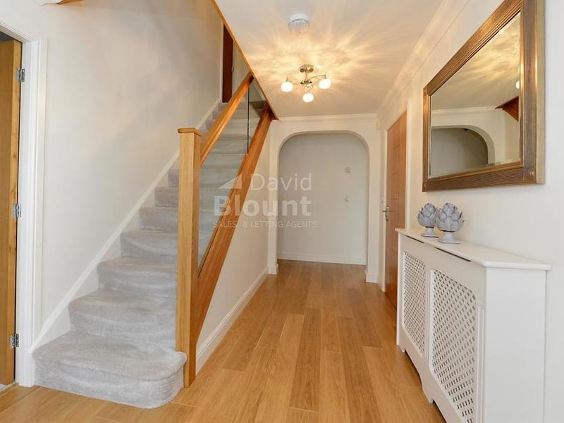 Another view of the attractive entrance hall. It includes a handy cupboard under the stairs.