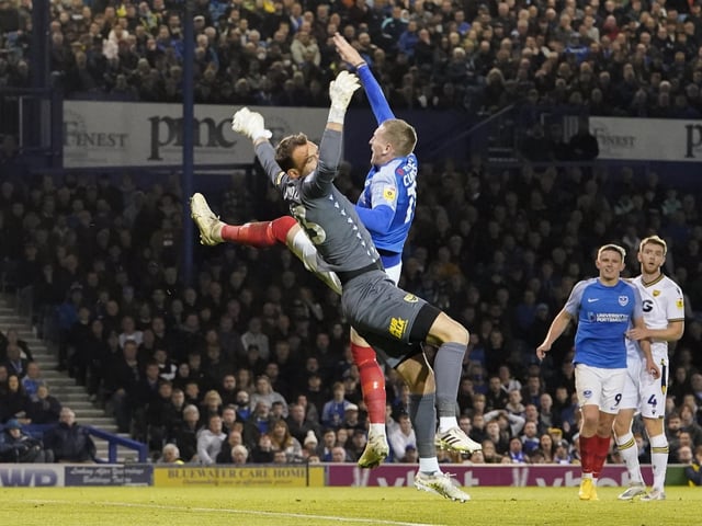 Pompey winger Ronan Curtis goes up for an aerial challenge with Oxford keeper Simon Eastwood