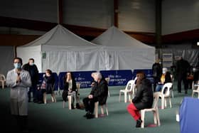 People wait after receiving a dose of COVID-19 vaccine at the vaccination center of Valenciennes, on March 23, 2021. (Photo by Yoan VALAT / POOL / AFP) (Photo by YOAN VALAT/POOL/AFP via Getty Images)