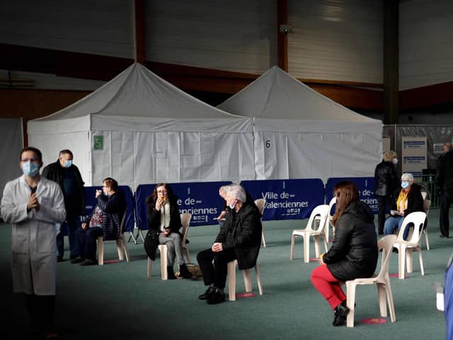 People wait after receiving a dose of COVID-19 vaccine at the vaccination center of Valenciennes, on March 23, 2021. (Photo by Yoan VALAT / POOL / AFP) (Photo by YOAN VALAT/POOL/AFP via Getty Images)