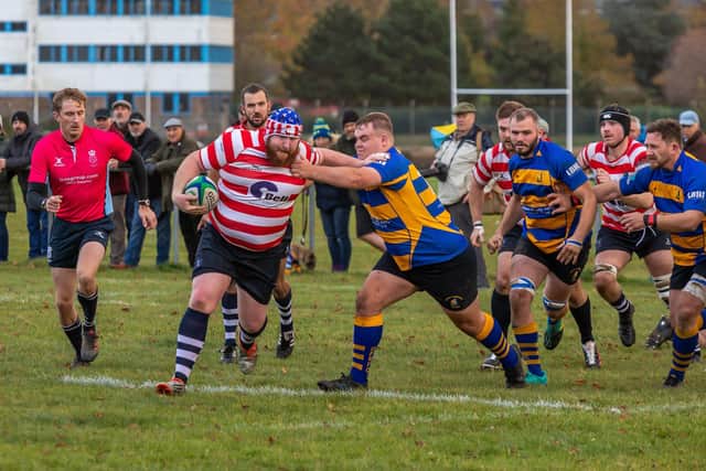 Havant's Peter Kewn fights off a Gosport & Fareham tackle. Picture: Mike Cooter
