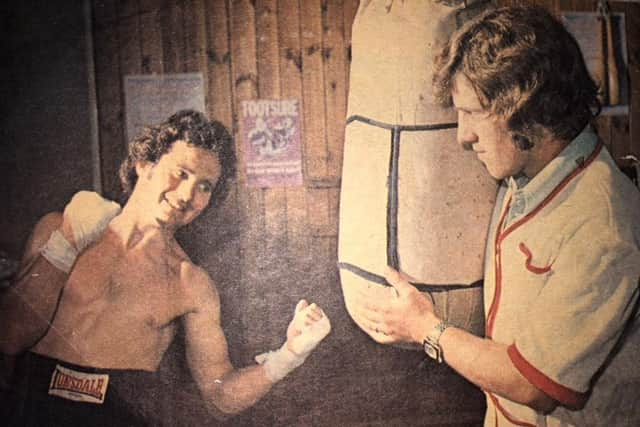 Harry Jones' grandad Ralph Evans, right, holds the bag for former professional Wayne Evans during a training session in 1975