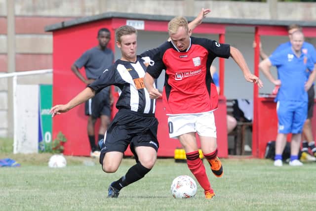Fareham's Ash Tattersall (red) in action against Hayling United during the FA Cup extra preliminary round held at Cams Alders.
Picture: Ian Hargreaves