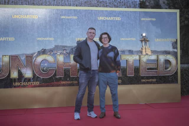 Tom Holland will play Nathan Drake in Ruben Fleischer's Uncharted. 
(Pictured: Director Ruben Fleischer and actor Tom Holland).