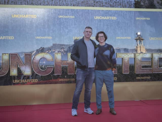 Tom Holland will play Nathan Drake in Ruben Fleischer's Uncharted. 
(Pictured: Director Ruben Fleischer and actor Tom Holland).