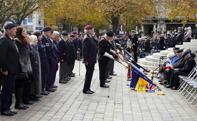 Standard bearers lower their standards during the Remembrance Service at the Guildhall Square, in Portsmouth. Picture date: Sunday November 14, 2021.