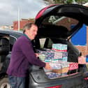 Rotarians Terry Dowland and Bob Mussellwhite, with boxes being checked and sent on their long festive journey to disadvantaged children overseas in time for Christmas.