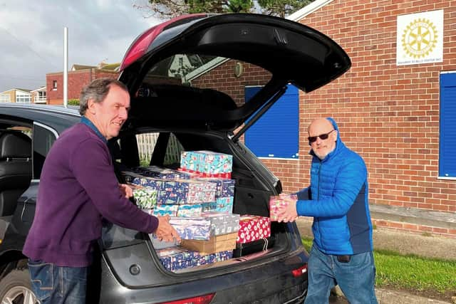 Rotarians Terry Dowland and Bob Mussellwhite, with boxes being checked and sent on their long festive journey to disadvantaged children overseas in time for Christmas.