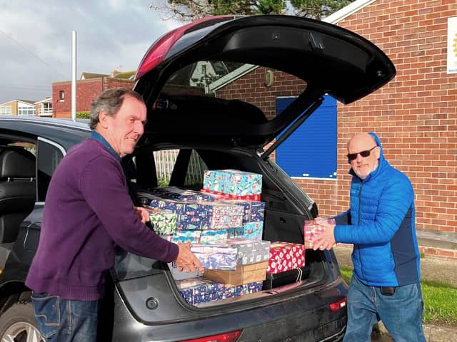 Rotarians Terry Dowland and Bob Mussellwhite, with boxes being checked and sent on their long festive journey to disadvantaged children overseas in time for Christmas.