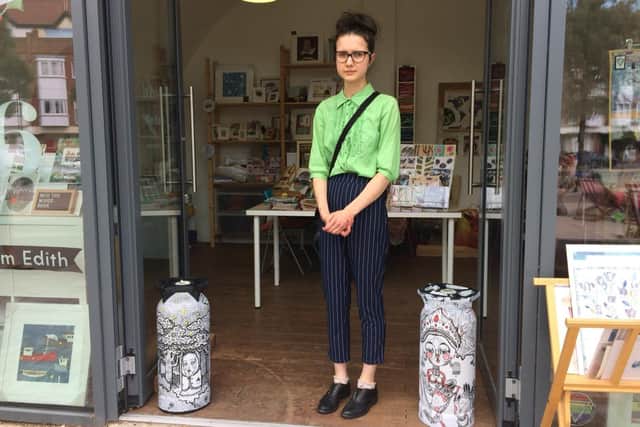 Vik Demjanova, 18 from Southsea, has been creating intricate murals on blank walls. Pictured: Vik with her works from the project at Hotwalls Gallery