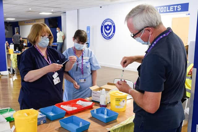 Preparing the doses at the Fratton Park walk-in vaccination centre. 

Picture: Keith Woodland (250721-17)