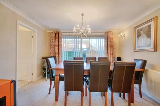 There is ample space for a good size dining table and chairs with carpeted flooring, a sliding patio door to the rear garden and a door to the kitchen.