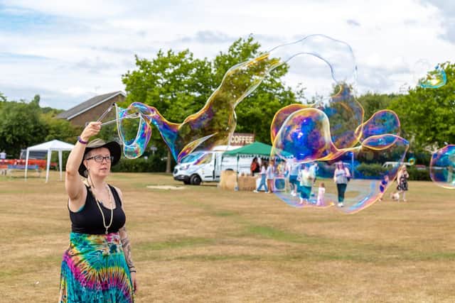 Bubble Witch Debbie Pickering entertains with her huge airborne creations. Picture: Mike Cooter (300722)