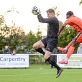 US Portsmouth keeper Tom Price gathers ahead of AFC Portchester's Toby Adekunle. Picture: Martyn White