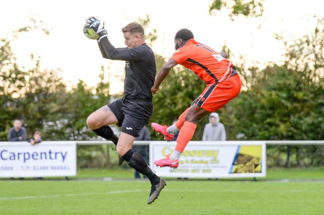 US Portsmouth keeper Tom Price gathers ahead of AFC Portchester's Toby Adekunle. Picture: Martyn White