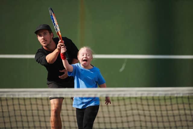 Tennis coach Ashley Neaves doing what he hasn't done much of recently - coaching on court.