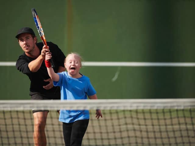 Tennis coach Ashley Neaves doing what he hasn't done much of recently - coaching on court.